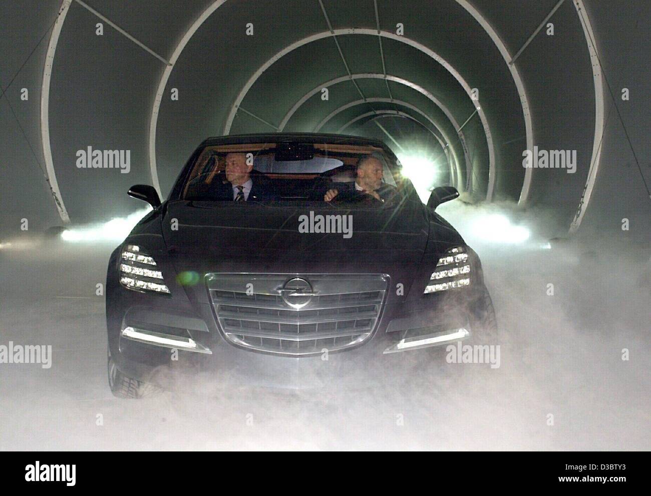 (dpa) - Two drivers drive the latest concept study model of Opel 'Insignia' on to the presentation stage before the start of the international automobile show IAA in Frankfurt main, Germany,  8 September 2003. Opel aims to participate in the production of upper medium range cars after years of absti Stock Photo