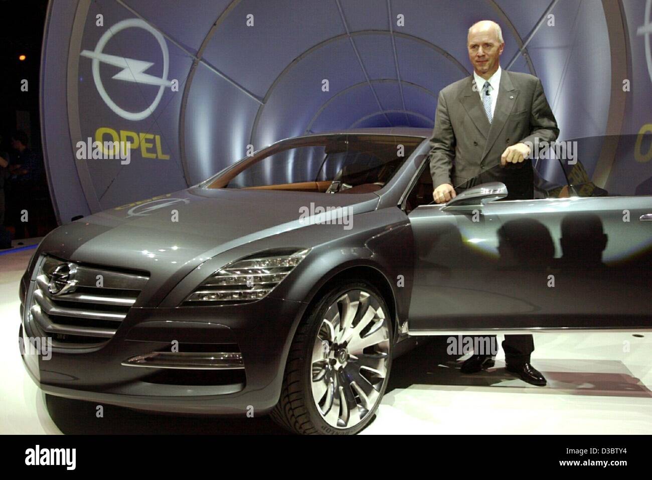 (dpa) - Carl-Peter Forster, Chairman of the Adam Opel AG, next to the latest concept study model of Opel 'Insignia' on to the presentation stage before the start of the international automobile show IAA in Frankfurt main, Germany,  8 September 2003. Opel aims to participate in the production of uppe Stock Photo