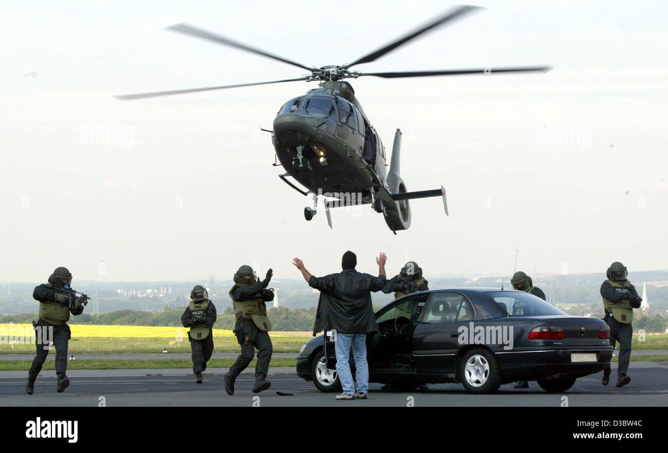 (dpa) - A special squad of the German police simulate the capture of two gangsters on the run with a vehicle, using the new high-tech helicopter type EC 155 in Dortmund, Germany, 3 September 2003. The police in the state of North Rhine Westphalia bought two of the state of the art helicopters. Stock Photo