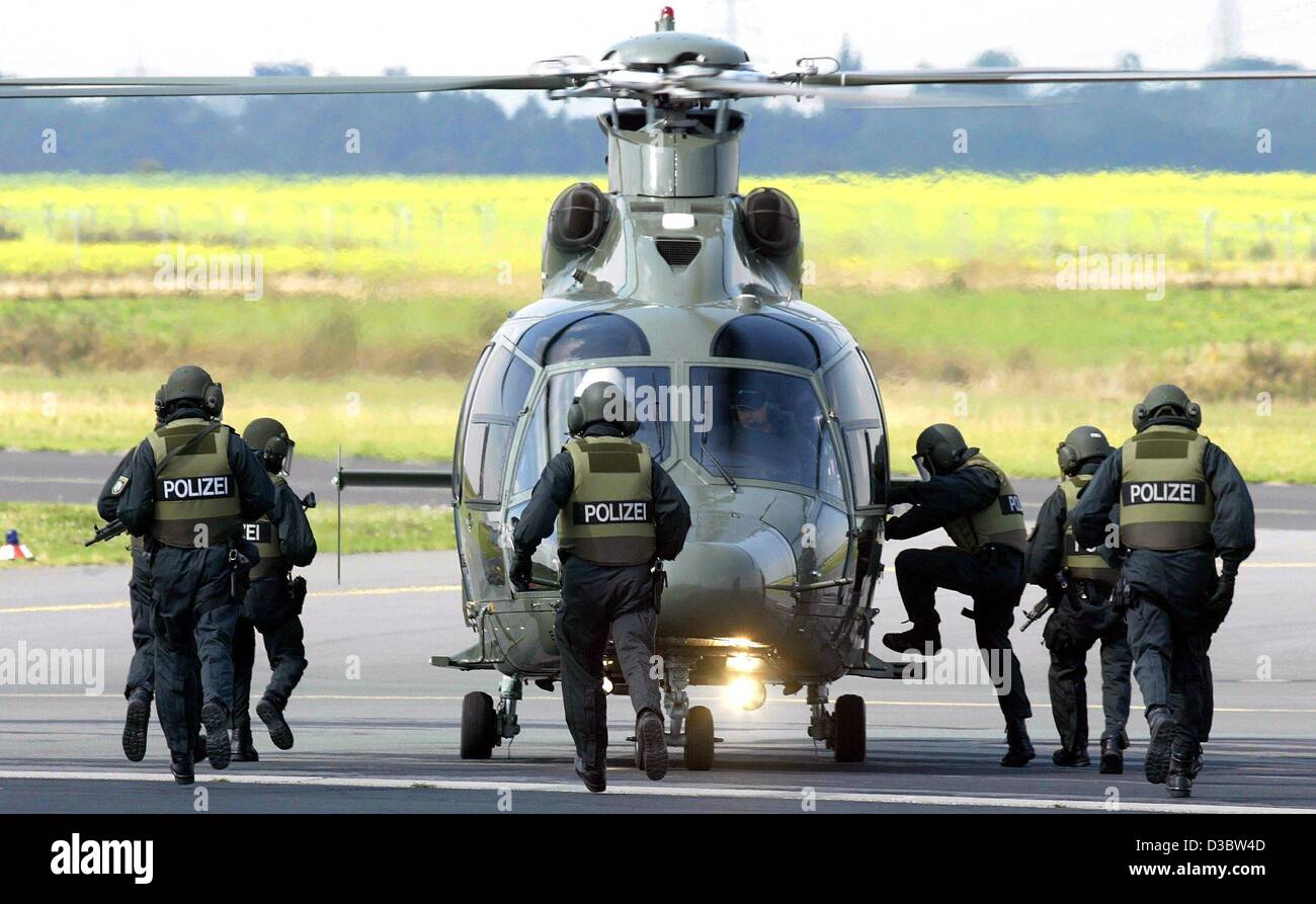 (dpa) - Policemen of a special squad of the German police mount the new high-tech helicopter type EC 155 in Dortmund, Germany, 3 September 2003. The police in the state of North Rhine Westphalia bought two of the state of the art helicopters. Stock Photo