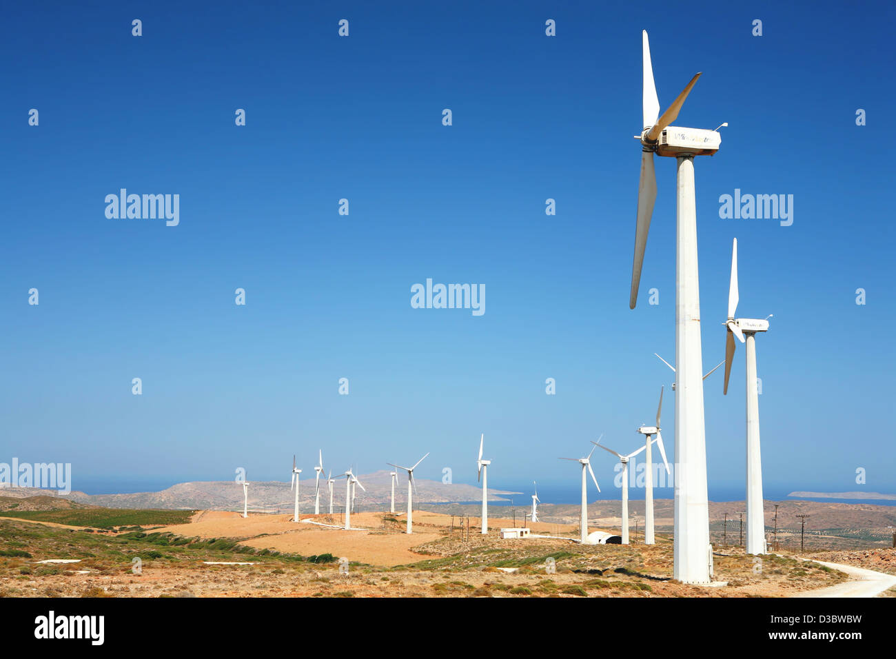A wind farm snaking its way across the barren landscape in the hills of ...