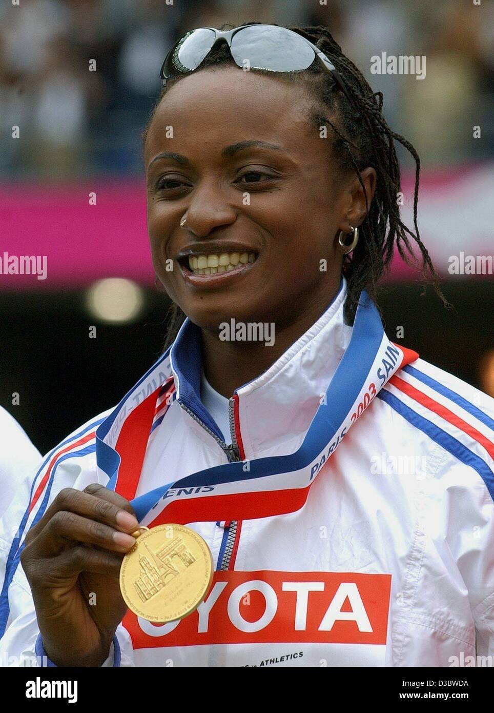 (dpa) - French athlete Eunice Barber poses with the gold medal which she had won at the women's long jump competition of the 9th IAAF Athletic World Championships at the Stade de France in Paris, 31 August 2003. She wins gold with a jump of 6.99 m. Stock Photo