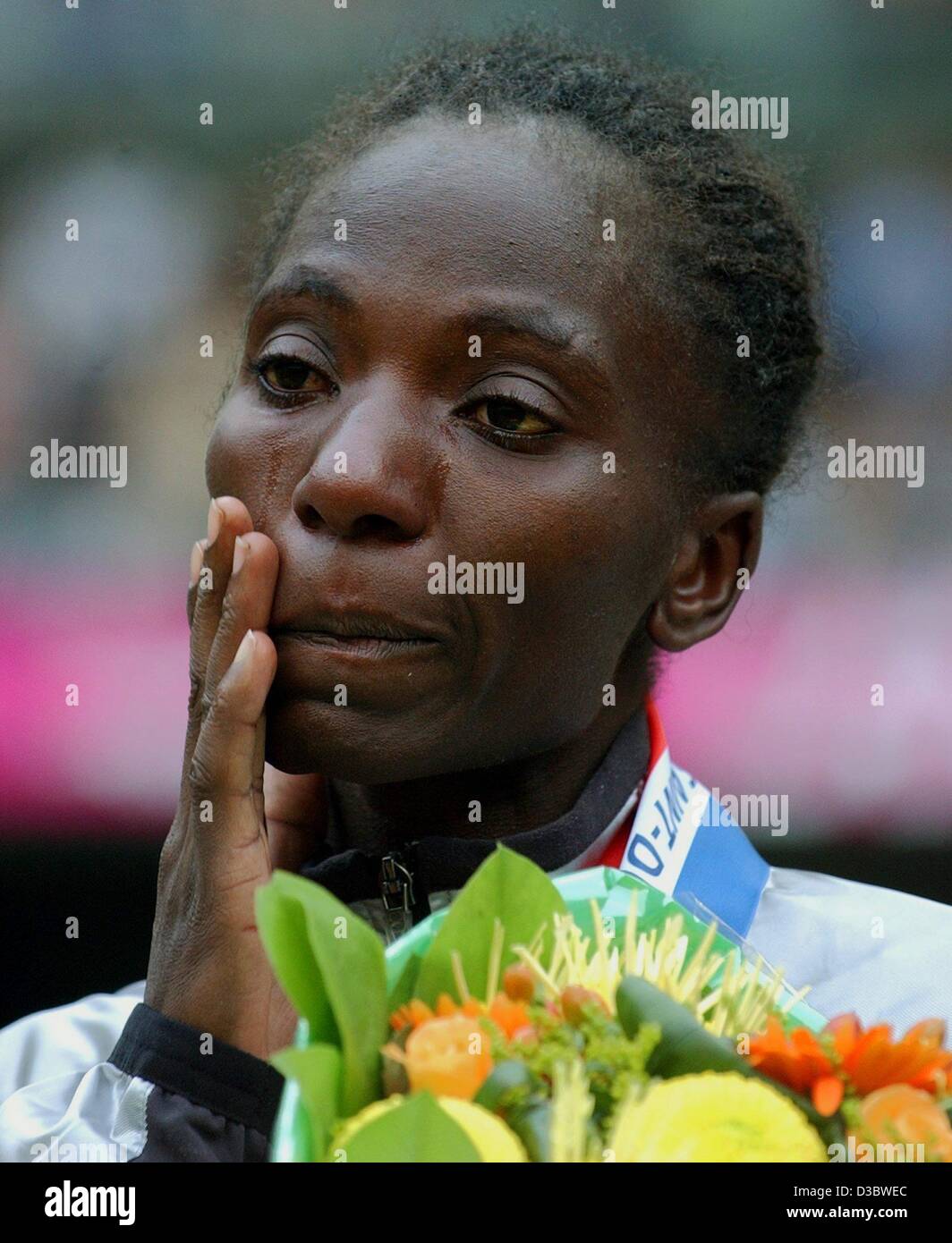(dpa) - Kenya's Catherine Ndereba cries on the podium after winning the women's marathon event at the 9th IAAF Athletic World Championships at the Stade de France in Paris, 31 August 2003. She wins the event in 2:23:55 h. Stock Photo