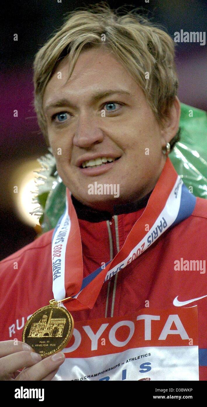 (dpa) - Russian Svetlana Krivelyova shows her gold medal which she won in the women's shot put competition at the 9th IAAF Athletics World Championships at the Stade de France in Paris, 27 August 2003. Stock Photo