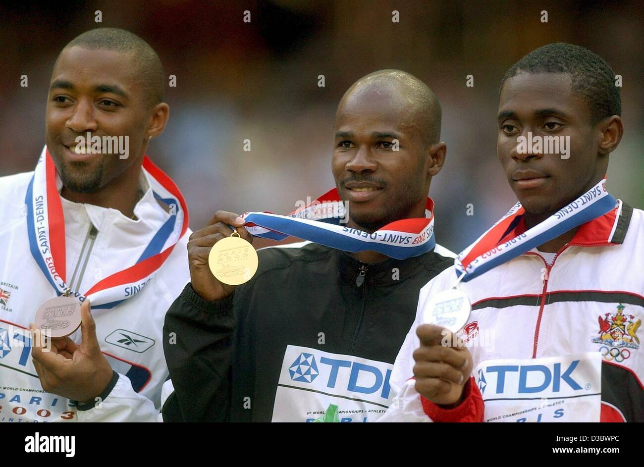 (dpa) - The winners of the men's 100 m sprint, silver-medal winner Darrel Brown from Trinidad and Tobago (R), gold-medal winner Kim Collins from Saint Kitts and Nevis (C) and third-placed Darren Campbell from Britain, pose with their medals on the podium at the 9th IAAF Athletic World Championships  Stock Photo