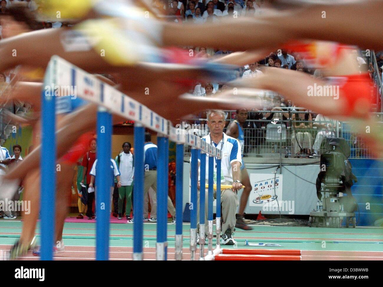 (dpa) - The participants of the 100 m hurdle event all clear a line of hurdles during the preliminaries at the 9th IAAF Athlectic World Championships at the Stade de France in Paris, 25 August 2003. Stock Photo