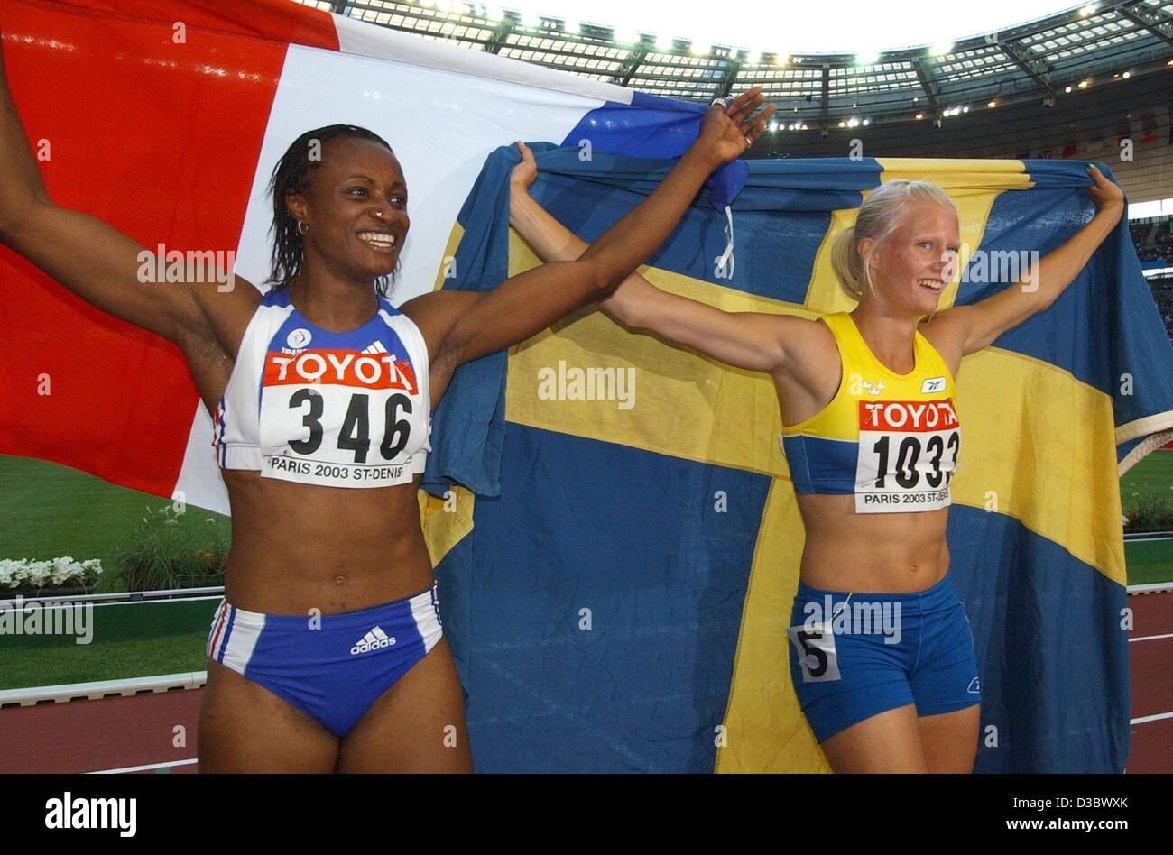 (dpa) - The two best-placed athletes of the heptathlon event wave their country's flags: Carolina Klueft from Sweden (R) wins the event with 7001 points and Eunice Barber from France wins second place with 6755 points in the women's heptathlon at the 9th IAAF Athletic World Championships at the Stad Stock Photo