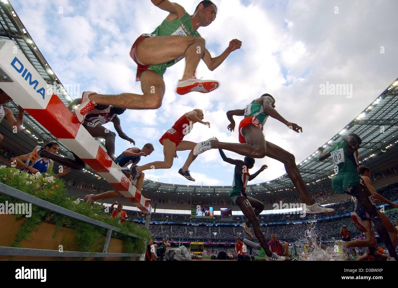 (dpa) - The runners of the 3,000 m steeple chase event clear a hurdle and a moat during the preliminaries at the 9th IAAF Athletic World Championships at the Stade de France in Paris, 23 August 2003. Stock Photo