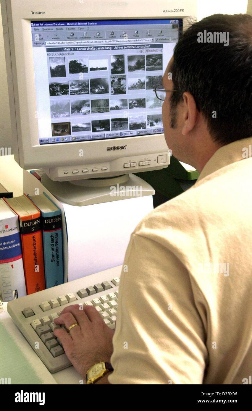 (dpa) - A man researches artworks on the internet, which were lost during the course of the Second World War, in Magdeburg, 24 June 2003. The database of the ministry of culture in Magdeburg comprises about 46,000 objects and is aimed at helping to find lost or looted artworks. Stock Photo