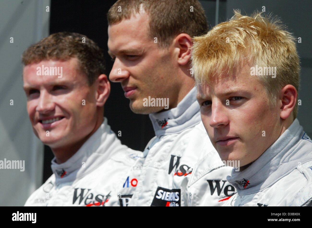 (dpa) - McLaren-Mercedes team members, (L-R:) Scotland's David Coulthard, test driver Alexander Wurz of Austria and Kimi Raeikkoenen of Finland, pose for the photographers at the Hungaroring circuit near Budapest, Hungary, 22 August 2003. McLaren-Mercedes will start with that same team in 2004. Stock Photo