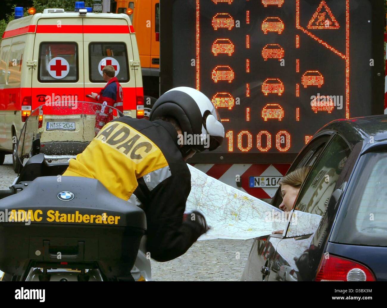 (dpa) - A traffic jam advisor of the German automobile club ADAC stops his motorbike next to a car in a traffic jam to advise a woman of alternative routes to avoid further traffic jams, photographed in a staged scene in Nuremberg, Germany, 4 July 2003. During the holiday season and the subsequent t Stock Photo