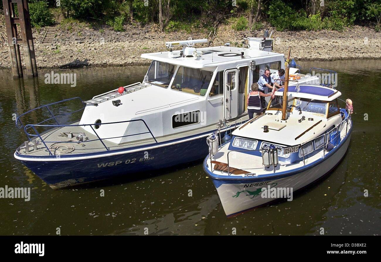 (dpa) - Officers of the German water police conduct a police check on a small motorboat on the River Elbe near Magdeburg, Germany, 17 July 2003. The river police registered around 296 offences within the first six months of this year. These are 27 more offences than in the same period of the previou Stock Photo