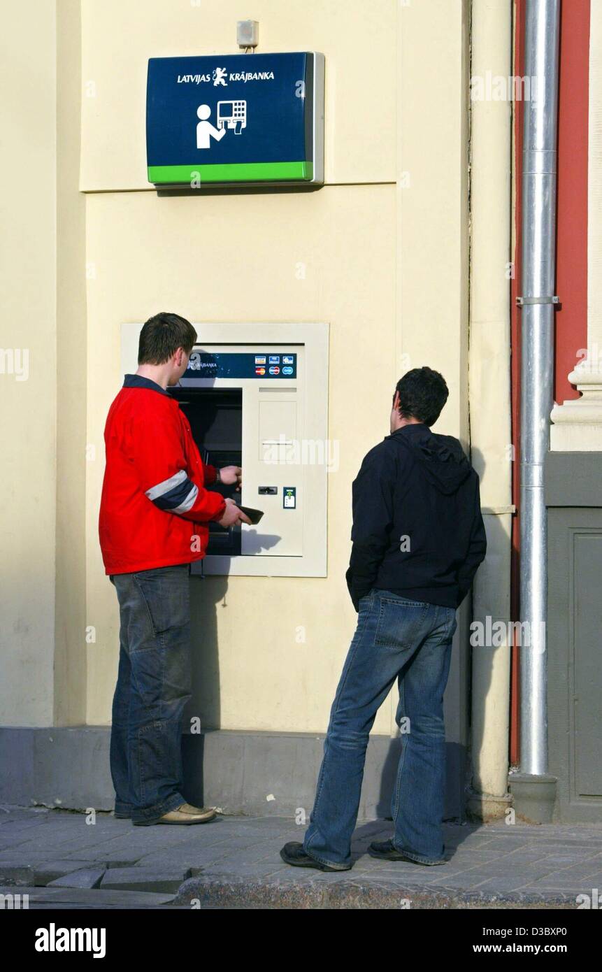 (dpa) - A customer draws money from a cash dispenser outside a bank in Riga, Latvia, 20 May 2003. Latvia, situated in northeastern Europe with a coastline along the Baltic Sea, is geographically the middle of the three Baltic countries. It shares much common history with its Baltic neighbours: in 19 Stock Photo