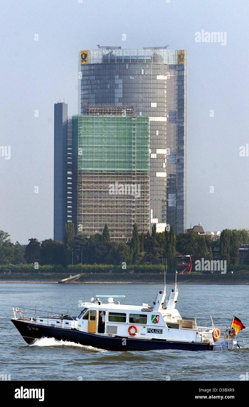 (dpa) - A police patrol boat WSP 5 of the river police passes on the River Rhine in front of the headquarter building of the German postal service Deutsche Post in Bonn, Germany, 4 August 2003. Stock Photo