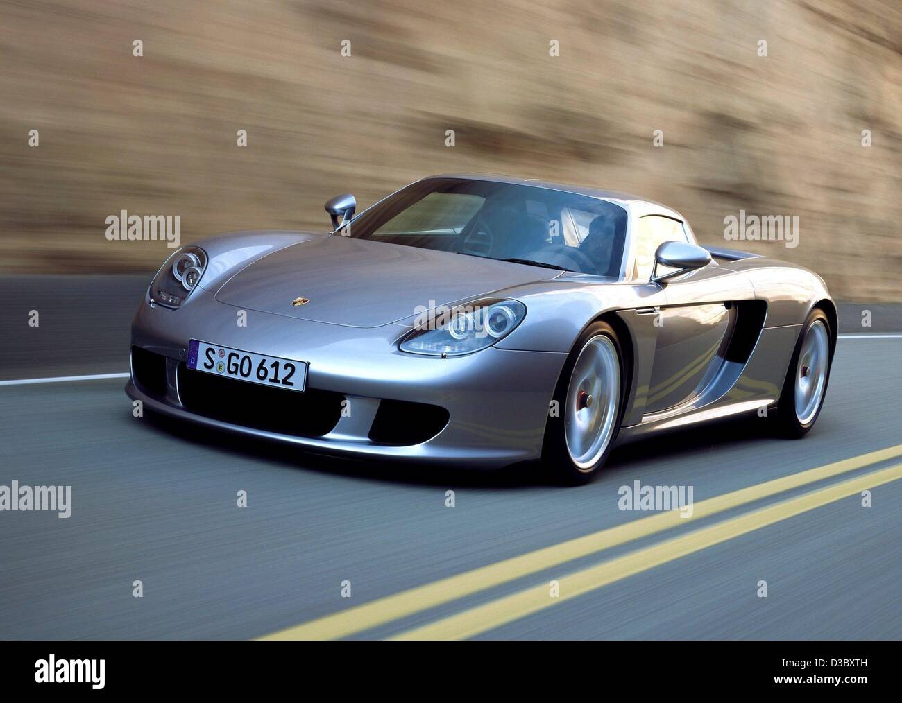 (dpa) - A handout shows the new Porsche Carrera GT (handed out by Porsche on 5 August 2003). Production of the Carrera starts in August in Leipzig, the first models are expected to be delivered this autumn. The Carrera will be the race car for the road: it has 612 hp, reaching a maximum speed of 330 Stock Photo