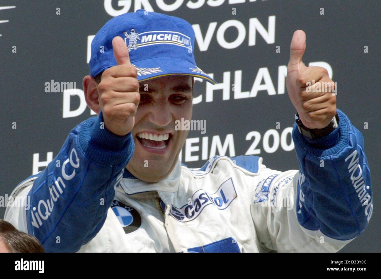 (dpa) - Colombian Juan Pablo Montoya of BMW-Williams celebrates on the podium after winning the Formula One Grand Prix of Germany at the Hockenheim race track in Hockenheim, Germany, 3 August 2003. With 65 points Montoya ranks now on 2nd place in the overall standings. Stock Photo