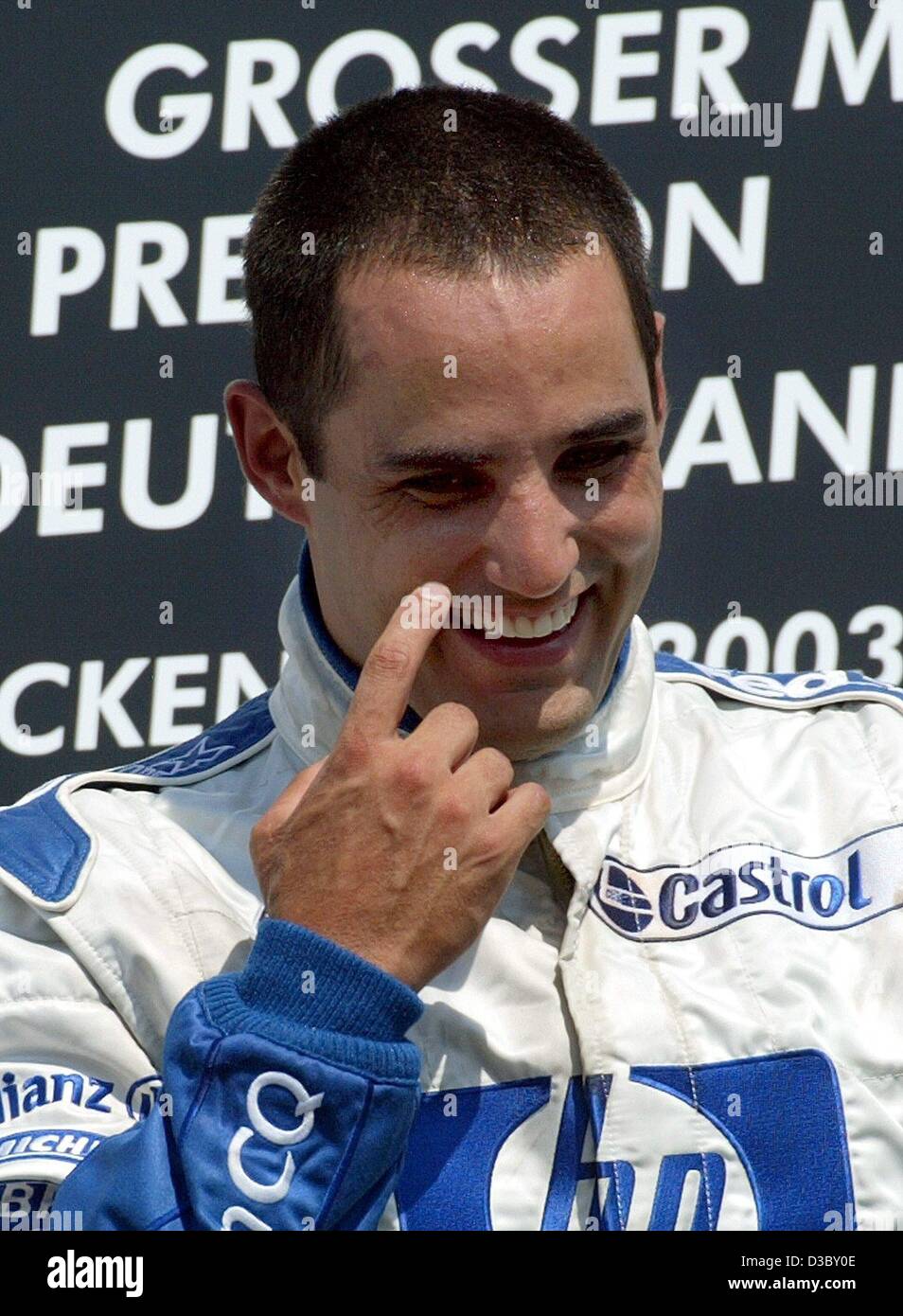 (dpa) - Colombian Juan Pablo Montoya of BMW-Williams smiles after winning the Formula One Grand Prix of Germany at the Hockenheim race track in Hockenheim, Germany, 3 August 2003. With 65 points Montoya ranks now on 2nd place in the overall standings. Stock Photo