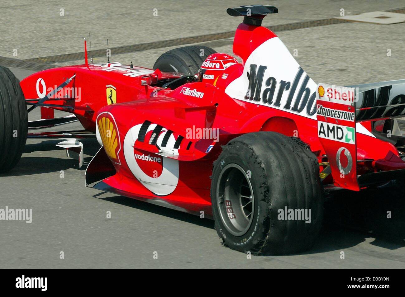 (dpa) - German formula one champion Michael Schumacher of Ferrari drives into the pitline with a burst tyre four laps before the end of the race, during the German Grand Prix at the Hockenheim race track in Hockenheim, Germany, 3 August 2003. Schumacher finished seventh place. Stock Photo