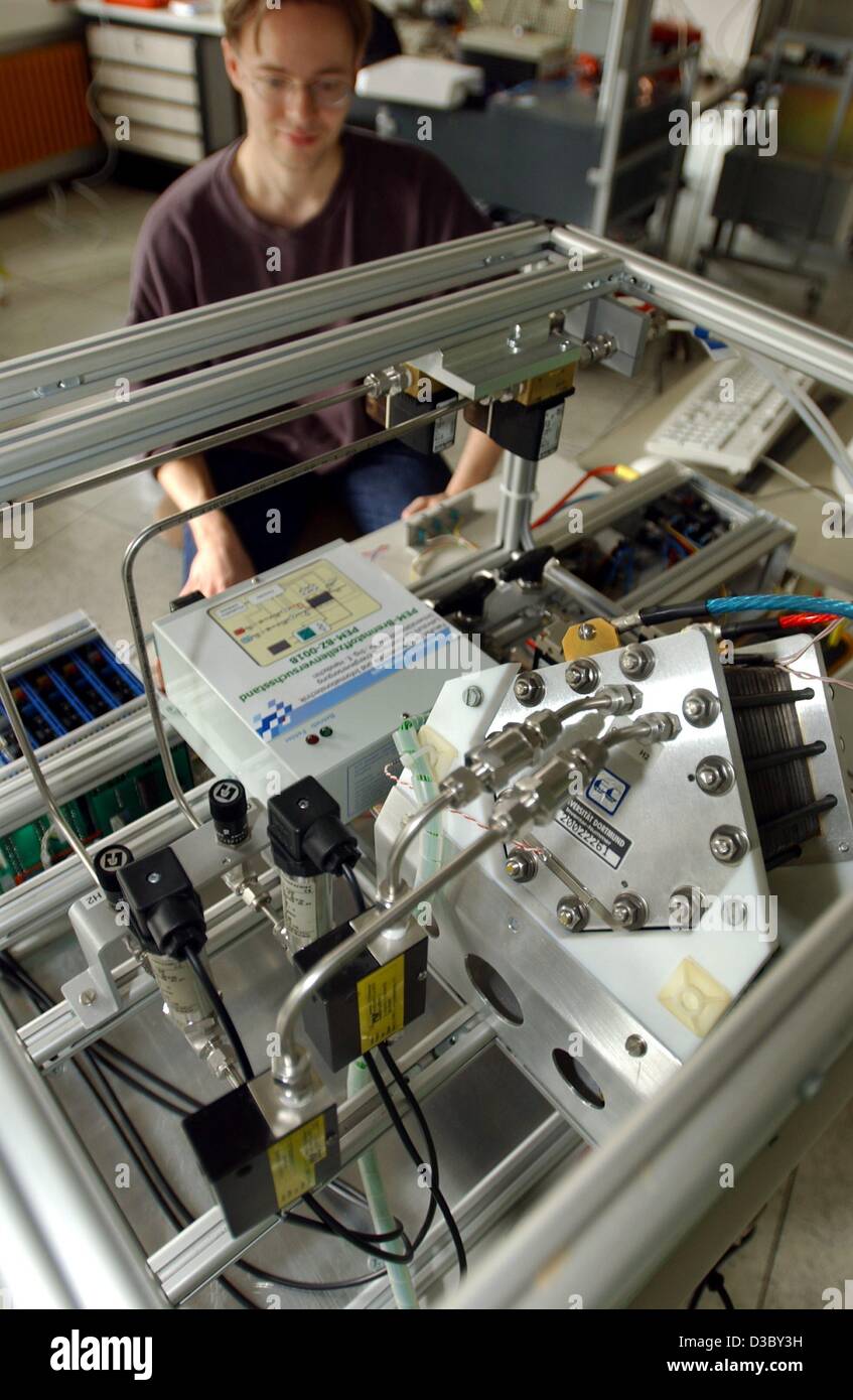 (dpa) - Daniel Hause, student at the university of Dortmund, works on a fuel cell test facility in Dortmund, Germany, 28 July 2003. The facility, developed by the department of electrical energy supply at the university of Dortmund, can test fuel cells with a performance of up to 1,000 Watt. Fuel ce Stock Photo