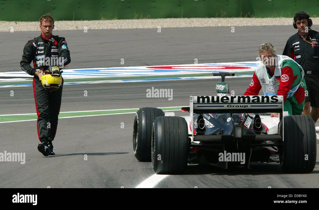 (dpa) - Danish formula one pilot Niclas Kiesa of Minardi (L) walks back to the pits after dropping out during the first qualifying training on the Hockenheim Ring race track in Hockenheim, Germany, 1 August 2003. The newcomer Kiesa replaces Justin Wilson, who is now driving for the Jaguar team, and  Stock Photo