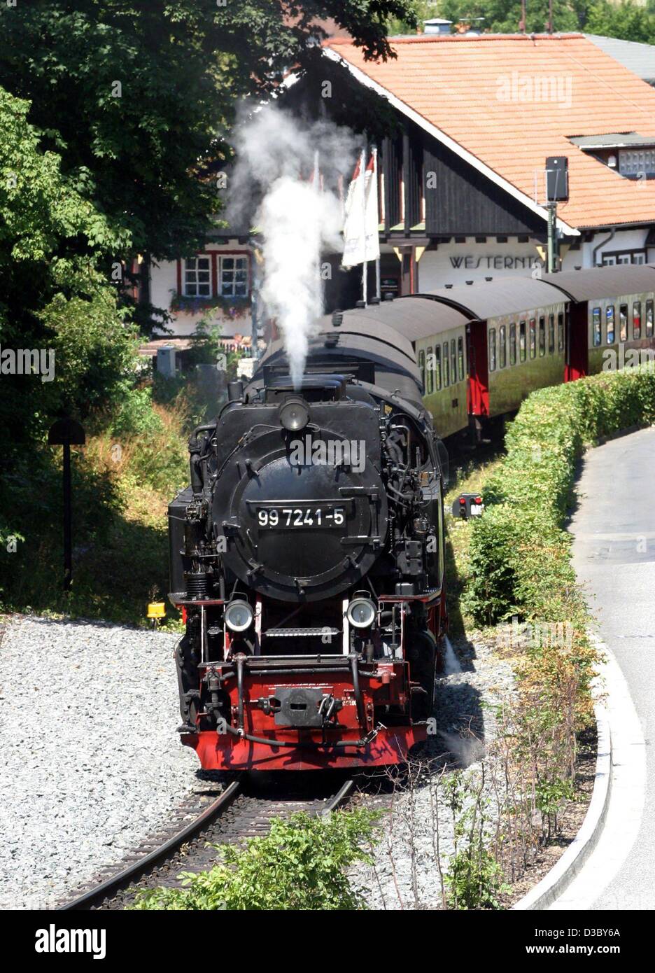 (dpa) - An engine of the Harzer narrow-gauge railway blows some steam as it climbs uphill from the train station Westerntor in Wernigerode, Germany, 15 July 2003. The historic railway line up the Brocken Mountain is a favourite tourist attraction in the region, attracting over 1.1 million customers  Stock Photo