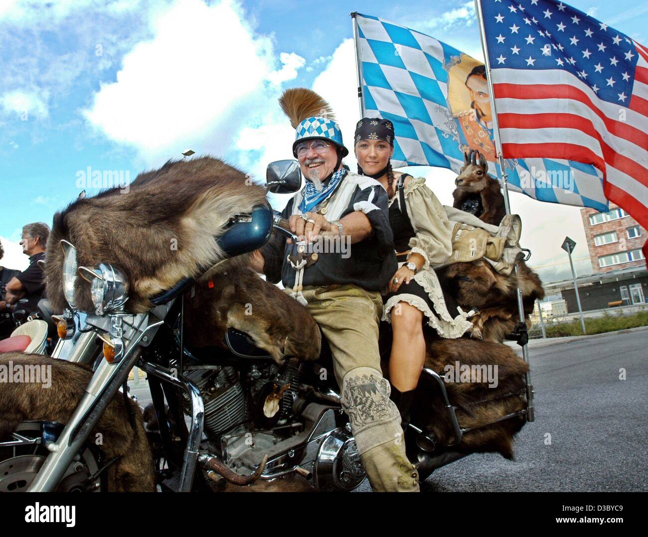 Biker Edgar Dinkel (L) from Munich and his daughter Sabine ride on their  Harley, which is adorned with all sorts of fur accessories, the Bavarian  and American flag, during the Harley Davidson