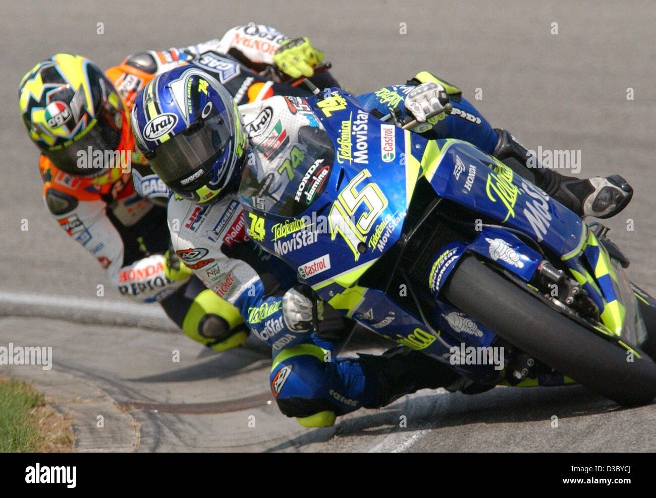 (dpa) - Spanish motorcycle pilot Sete Gibernau (front, Honda) races through a curve followed by Italian title defender Valentino Rossi (Honda) during the MotoGP race of the German Grand Prix on the Sachsenring near Hohenstein-Ernstthal, Germany, 27 July 2003. Gibernau wins first place. Stock Photo