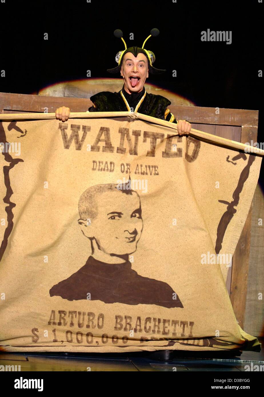 (dpa) - With a huge 'Wanted' poster the Italian quick-change artist Arturo Brachetti performs on stage during a press show in Cologne, Germany, 25 July 2003. From 24 July to 10 August the artist will perform his show 'Der Mann mit den tausend Gesichtern' (the man with the 1000 faces) in Cologne. Wit Stock Photo