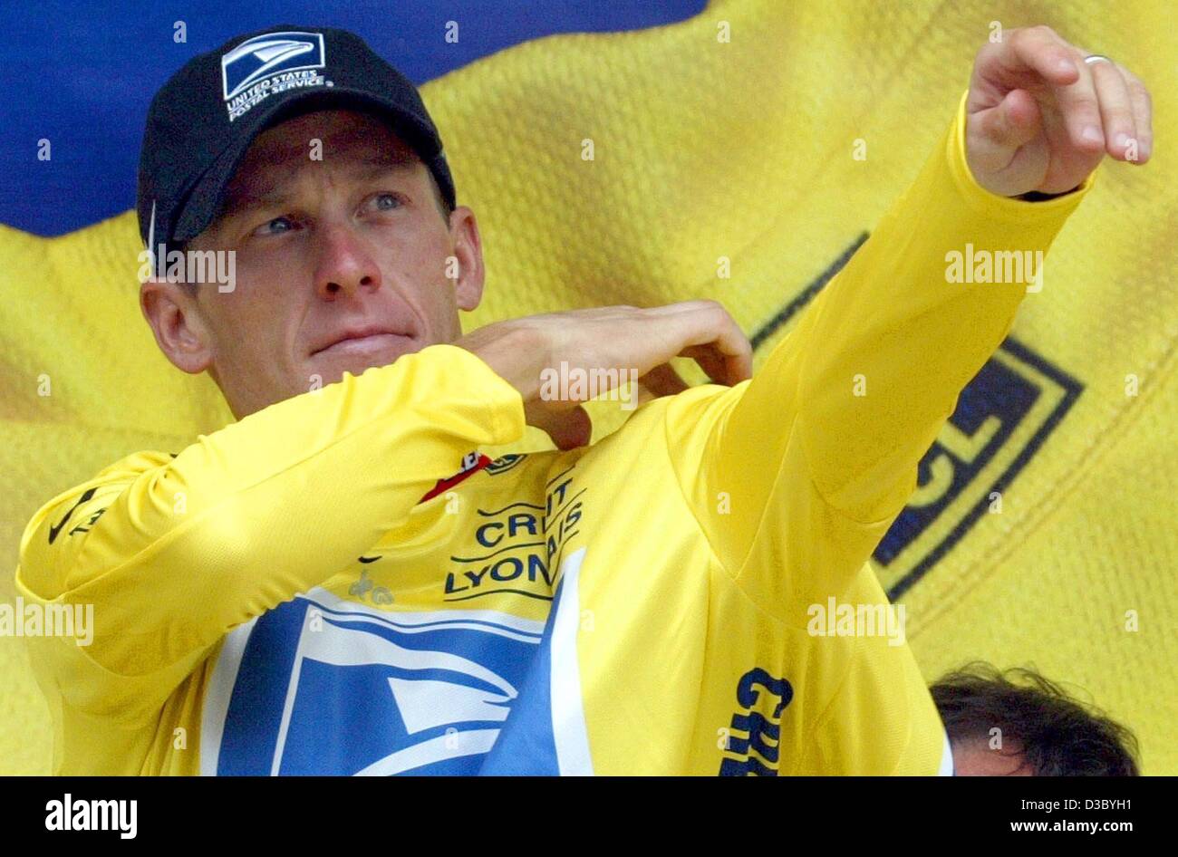 (dpa) - US Postal-Berry Floor's Lance Armstrong from the US puts on the overall leader's yellow jersey after the 17th stage of the 2003 Tour de France cycling race in Bordeaux, 24 July 2003. The 181.5km long 17th stage of the world's biggest cycling race led the cyclists from Dax to Bordeaux. Stock Photo