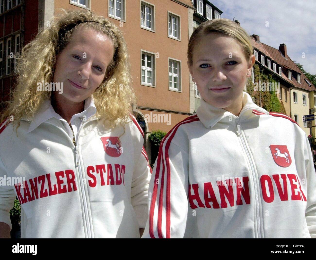 (dpa) - Helle Poltermann (L) and Tatjana Lapatin wear the new track suits featuring the emblem of the state of Lower Saxony and in big letters 'Kanzler-Stadt' (chancellor city) and 'Hannover' respectively, in Hanover, Germany, 18 July 2003. The new fashion is available in a boutique and costs 59 eur Stock Photo