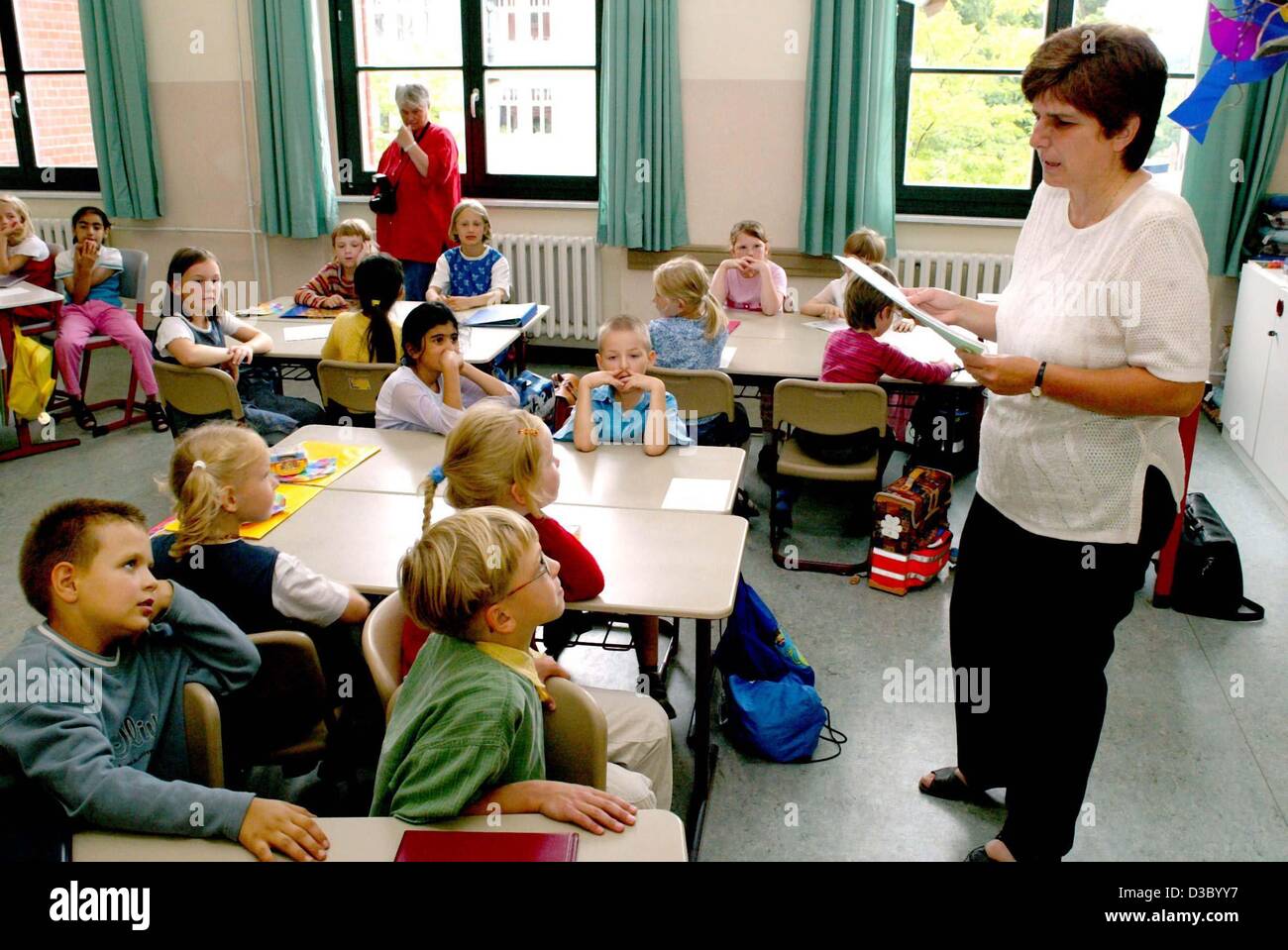 (dpa) - First graders await the distribution of their first end-of-year school reports at an elementary school in Magdeburg, Germany, 9 July 2003. The day was also the last day of school before the start of the summer holidays. Stock Photo