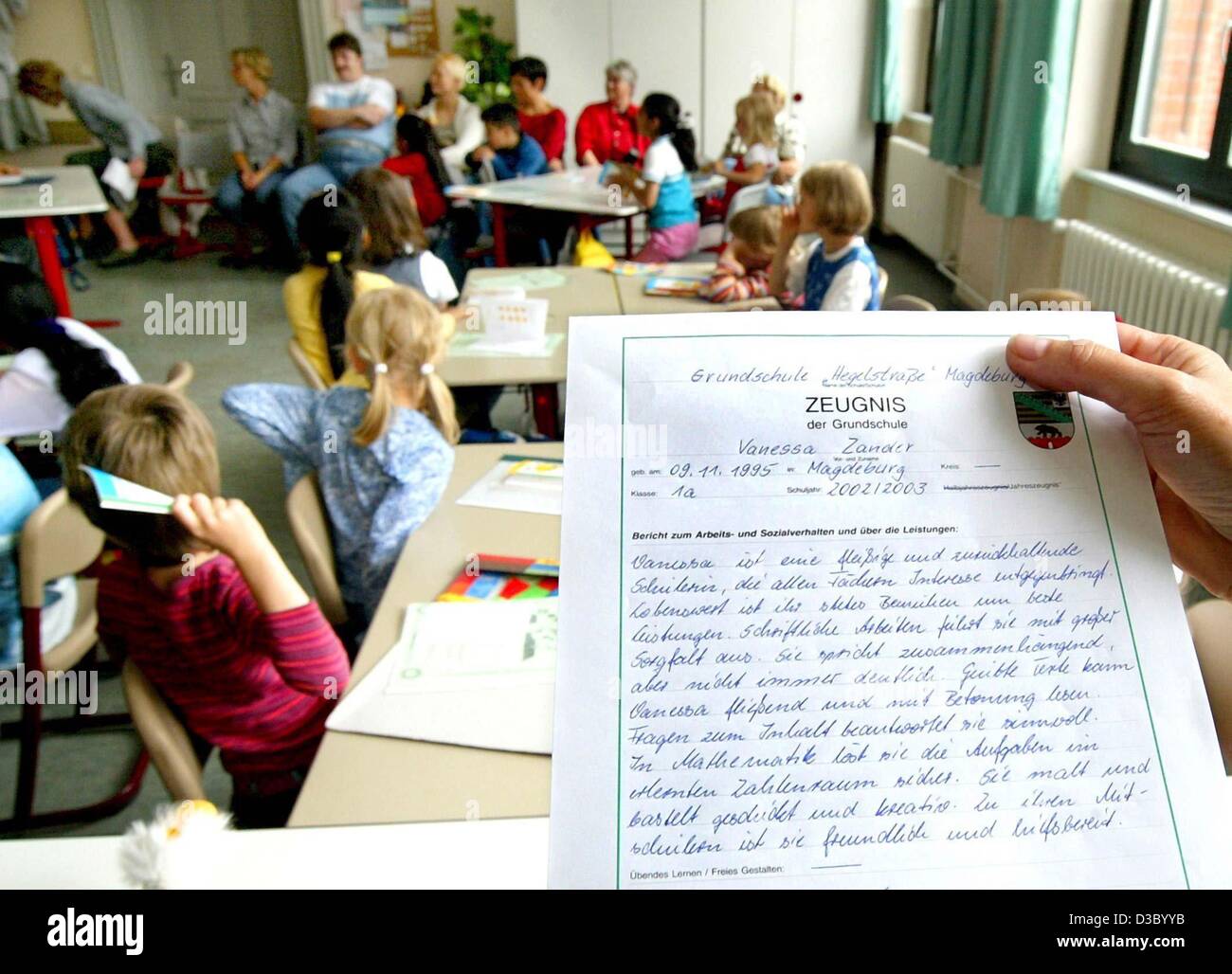 (dpa) - First graders await the distribution of their first end-of-year school reports ('Zeugnis') at an elementary school in Magdeburg, Germany, 9 July 2003. The day was also the last day of school before the start of the summer holidays. Stock Photo