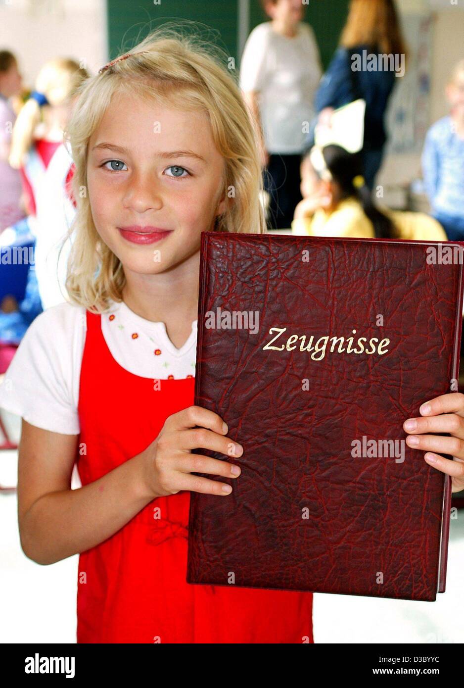 (dpa) - First grader Anna-Charlott John shows the folder containing her first end-of-year school report ('Zeugnis') at an elementary school in Magdeburg, Germany, 9 July 2003. The day was also the last day of school before the start of the summer holidays. Stock Photo