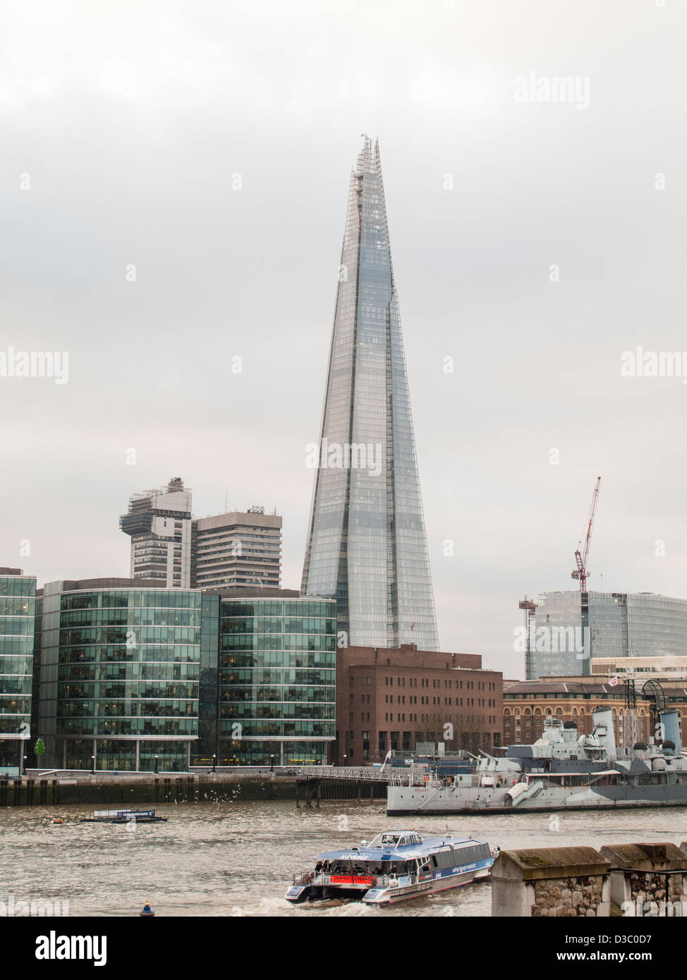 The Shard and London Bridge City viewed from the Tower of London across the River Thames on a cloudy day Stock Photo