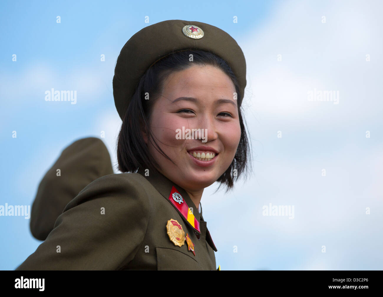 Smiling Female Soldier In Tower Of The Juche Idea, Pyongyang, North Korea Stock Photo