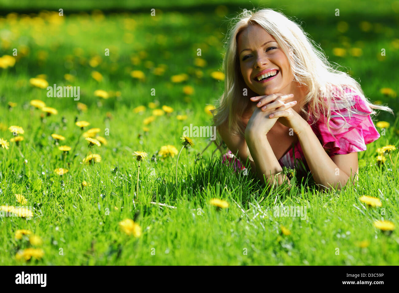 girl lying on the field of dandelions Stock Photo - Alamy