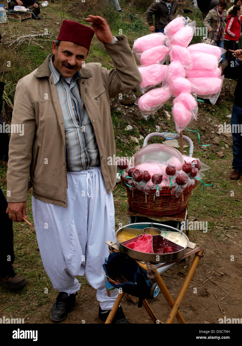 Turkish man in fez hat selling candy during Selcuk-Efes Camel Wrestling Festival, Turkey. Stock Photo
