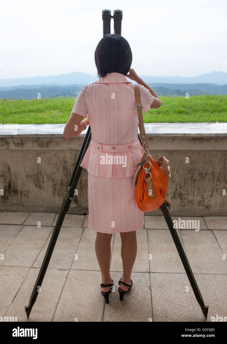 North Korean Woman Looking At South Korea From The Wall Section, Dmz, Panmunjom, North Korea Stock Photo