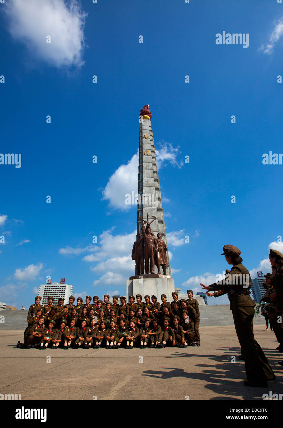 Female Soldiers Pausing In Front Of Tower Of The Juche Idea, Pyongyang, North Korea Stock Photo