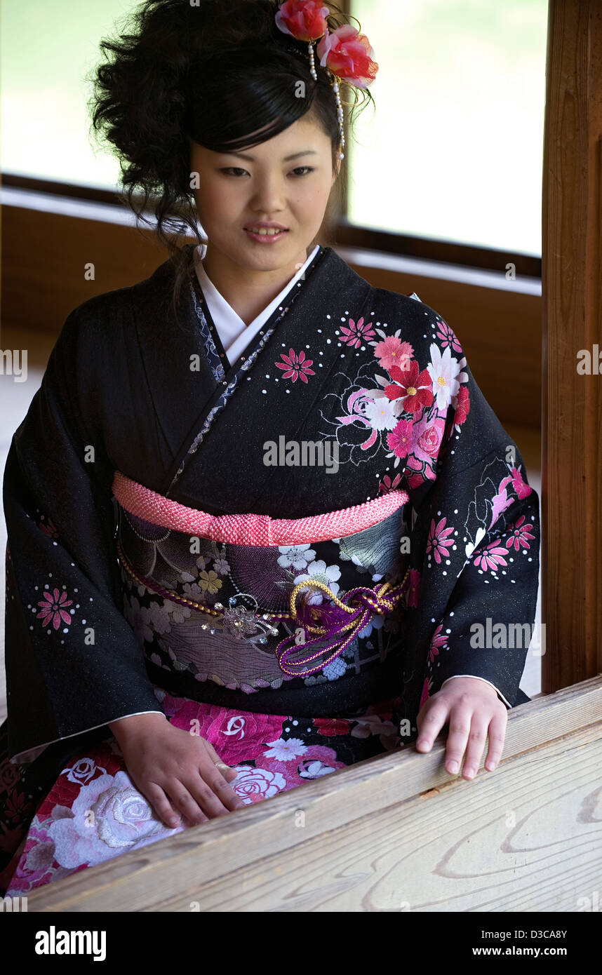 Beautiful 19-year-old Japanese girl wearing traditional furisode long-sleeve kimono with spring flower design in Fukui, Japan. Stock Photo