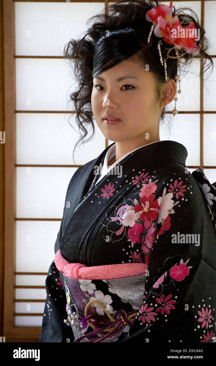 Beautiful 19-year-old Japanese girl wearing traditional furisode long-sleeve kimono with spring flower design in Fukui, Japan. Stock Photo