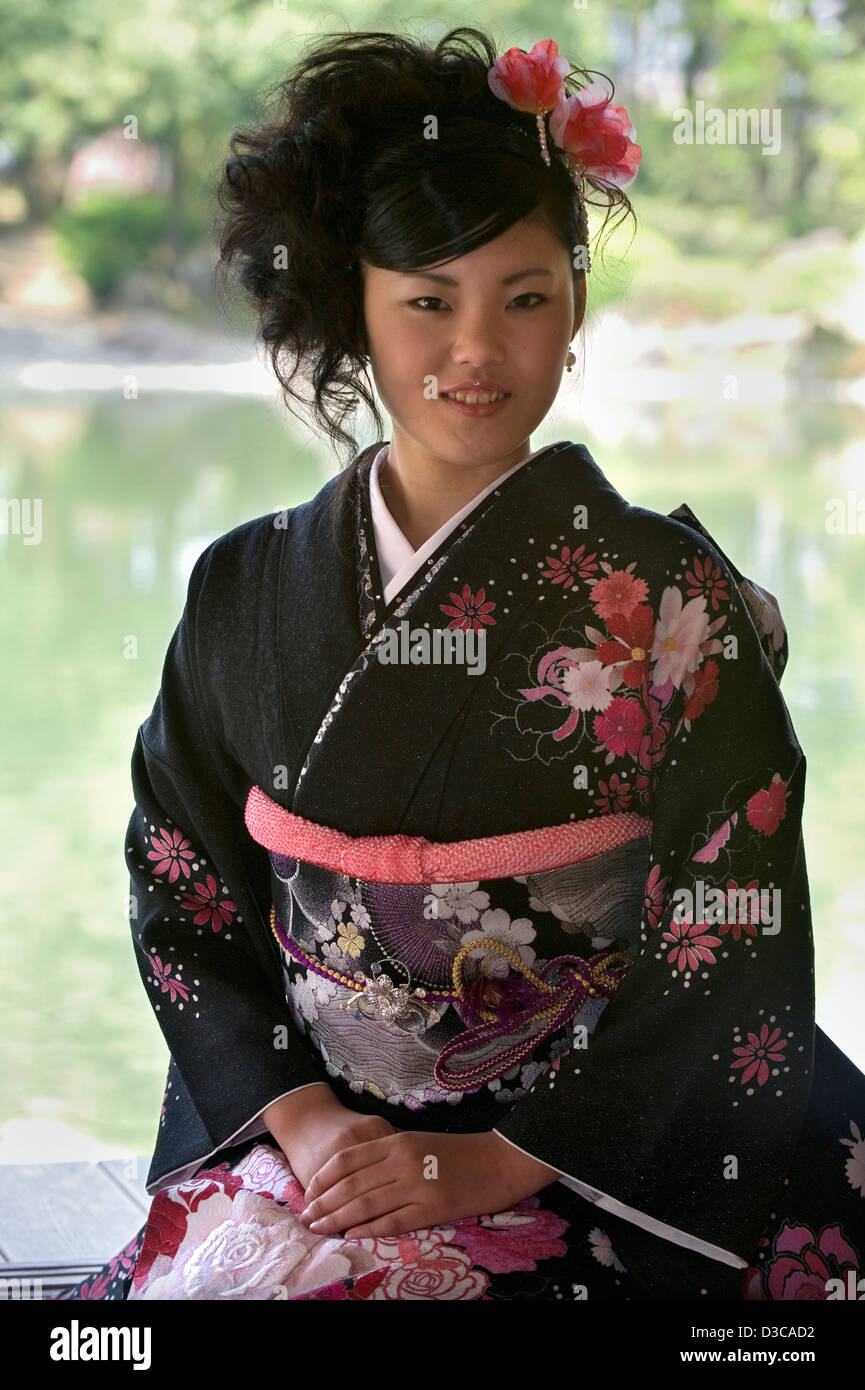 Beautiful 19-year-old Japanese girl wearing traditional furisode long-sleeve kimono with spring flower design in Fukui, Japan. Stock Photo