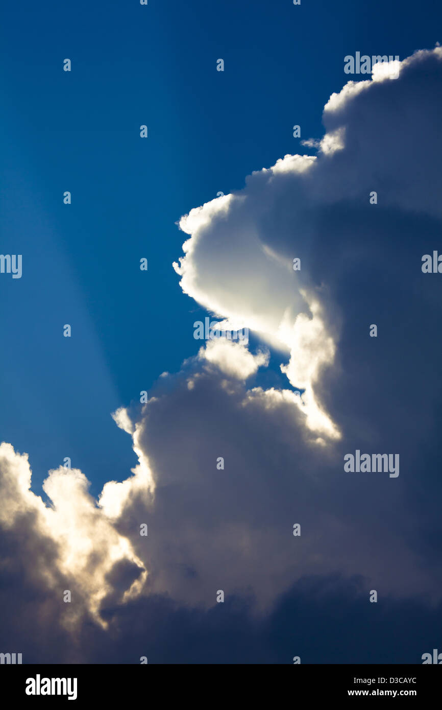 Sky, Sunrays Shining Through Cumulus Nimbus Clouds, Silver Lining At The Edge Of The Cloud. Stock Photo