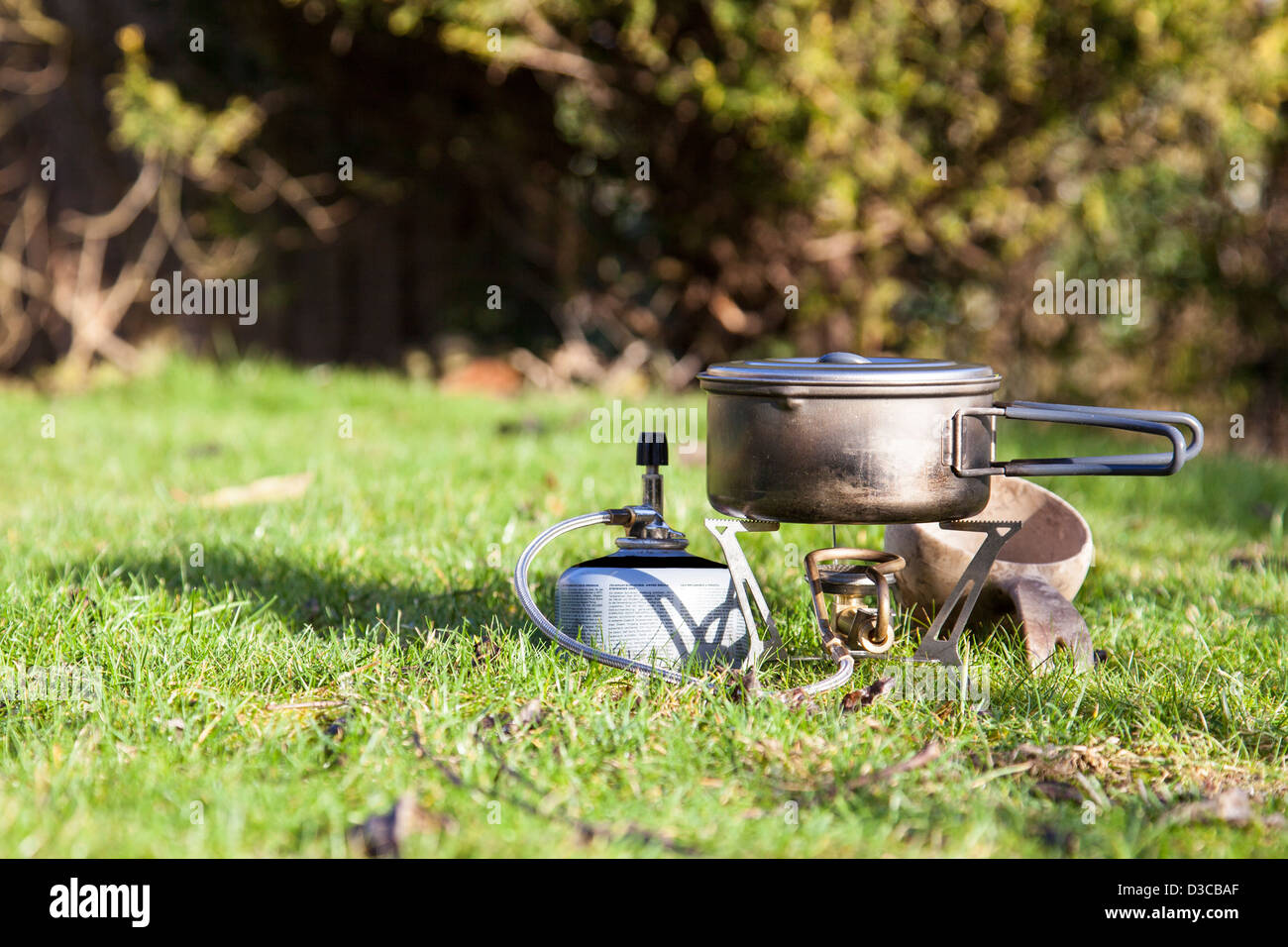 Camping Stove with Gas Canister and Wooden Mug Stock Photo Alamy