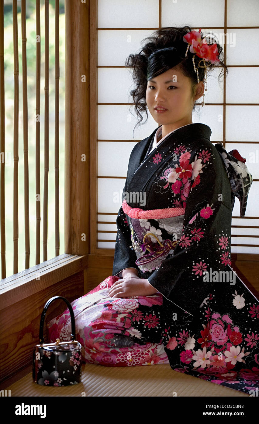 Beautiful 19-year-old Japanese girl wearing traditional furisode long-sleeve kimono with spring flower design in Fukui, Japan. Stock Photo