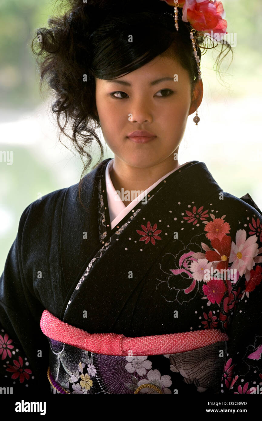 Beautiful 19-year-old Japanese girl wearing traditional furisode long-sleeve kimono with spring flower design in Fukui, Japan. Stock Photo