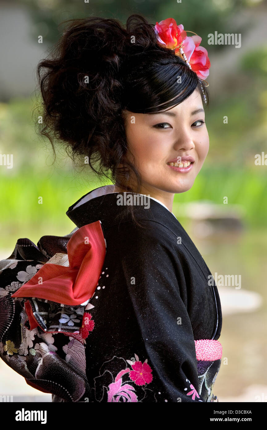 Beautiful 19-year-old Japanese girl wearing traditional furisode long-sleeve kimono with spring flower design in Fukui, Japan. Stock Photo