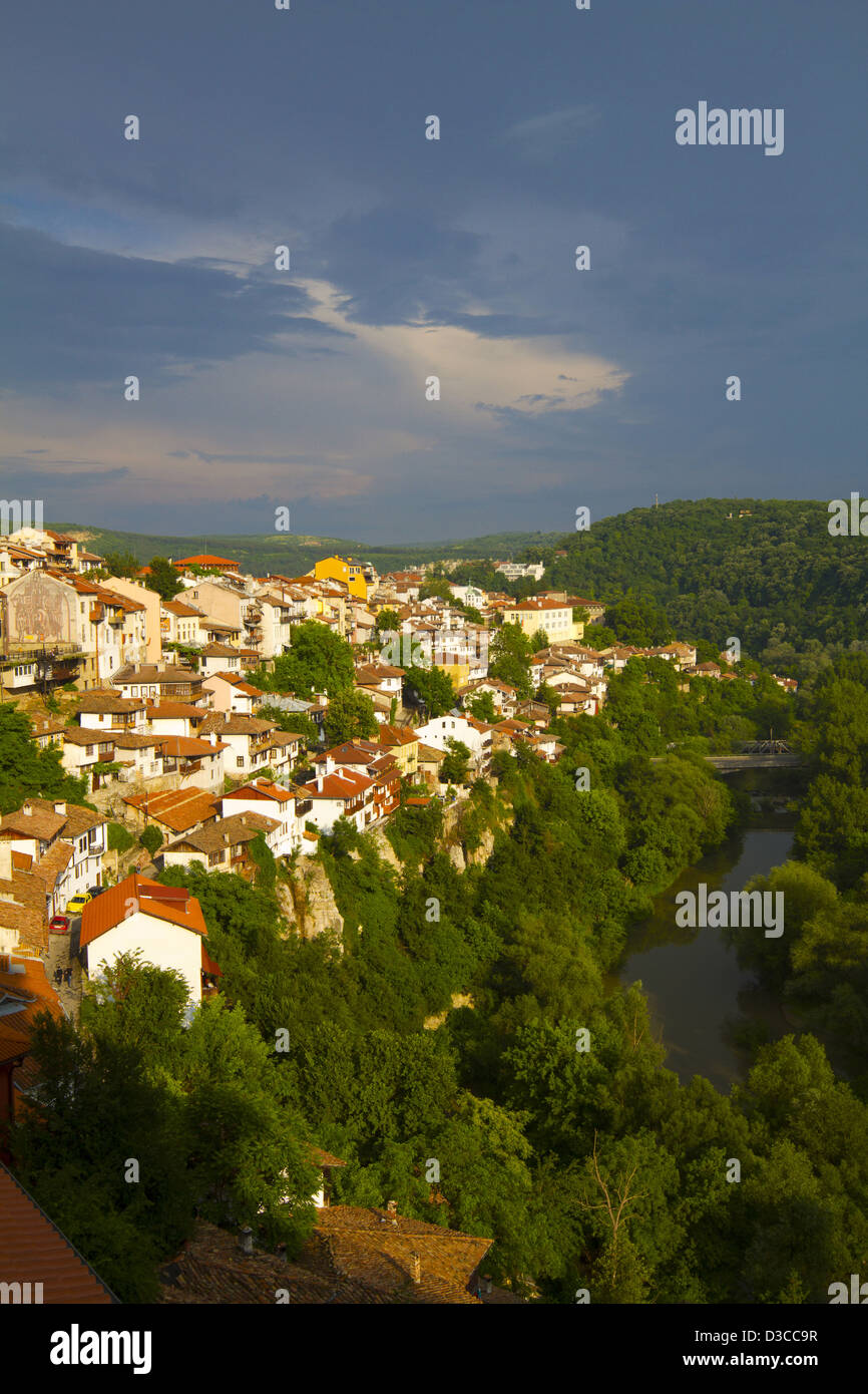 Bulgaria, Europe, Veliko Tarnovo, Hillside Houses Towering Above The Yantra River, Stormy Weather At Dusk. Stock Photo
