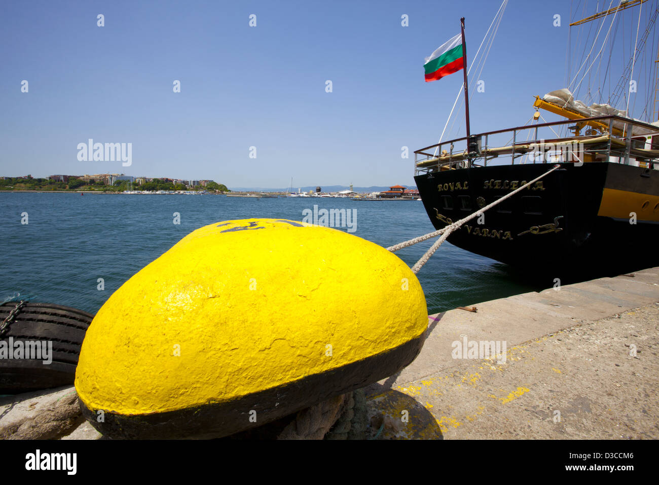 Bulgaria, Europe, Black Sea, Nessebar, Seaport, Harbor, Moored Ship, Mooring Line Tied To Yellow Bollard, Bulgarian Flag Stock Photo