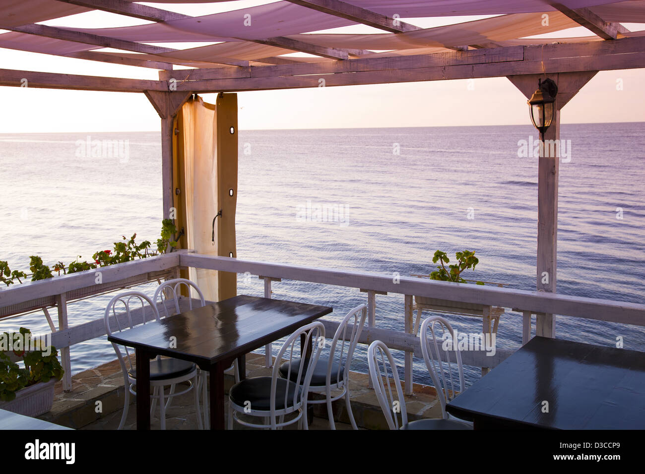 Bulgaria, Europe, Black Sea, Nessebar, Restaurant Dining Tables Overlooking The South Bay Harbor At Sunrise. Stock Photo